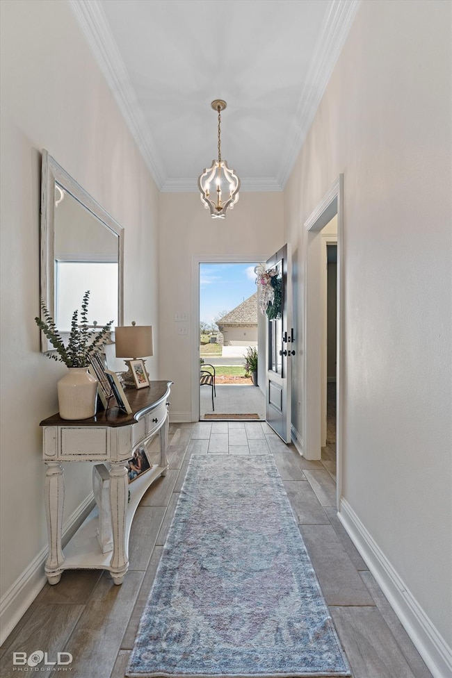 Entrance foyer featuring crown molding, baseboards