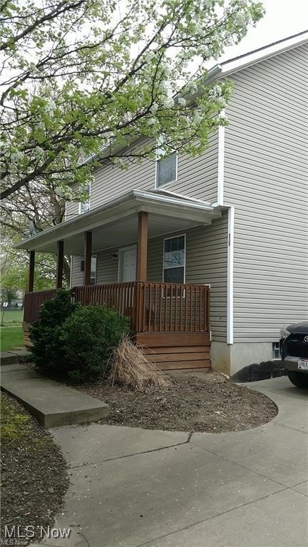 View of side of home featuring a porch