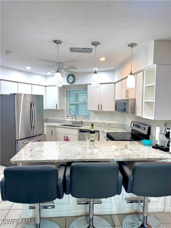 Kitchen with stainless steel appliances, a peninsu