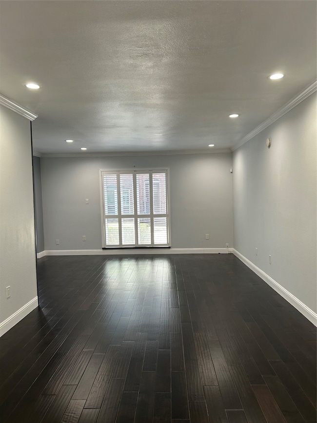 Another view of the spacious family room with wood flooring.