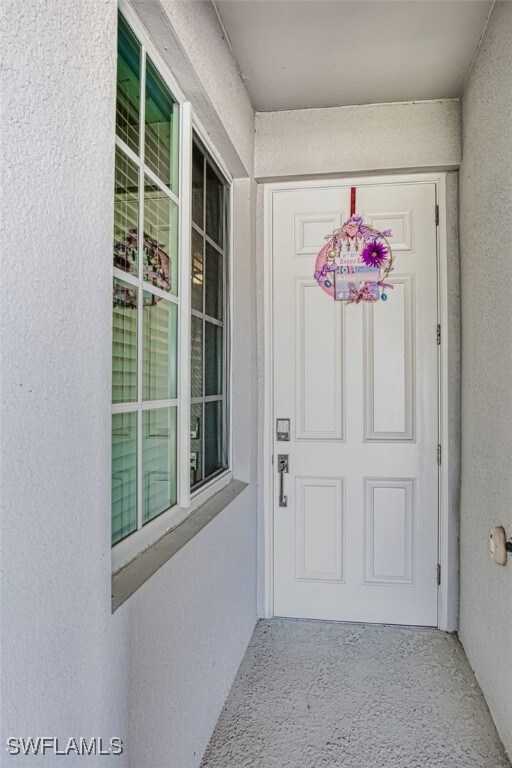 Property entrance with stucco siding