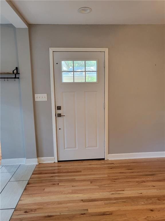 Entrance foyer with light wood-style flooring and baseboards