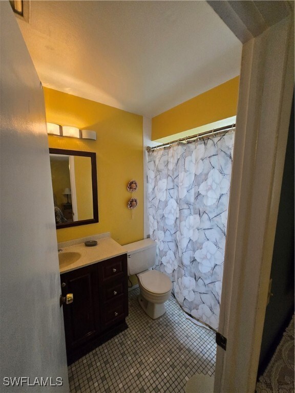 Full bathroom featuring vanity and tile patterned