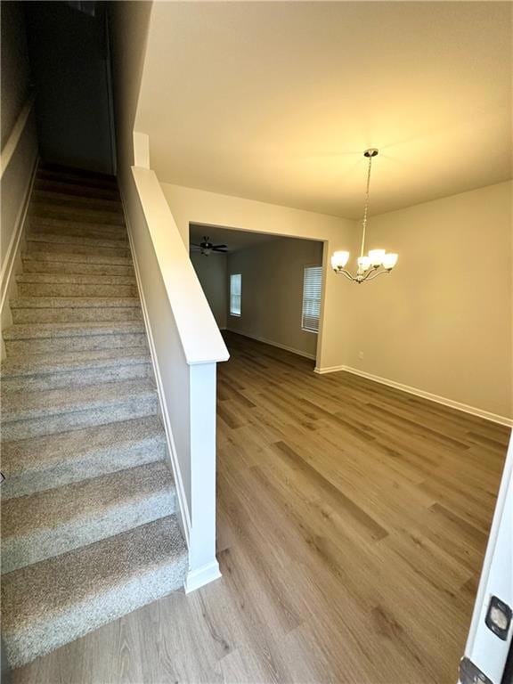 Stairs with ceiling fan with notable chandelier an