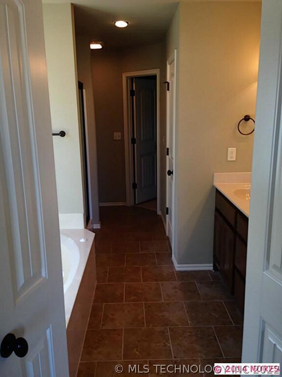 Master Bath  leading into large master closet. Inc