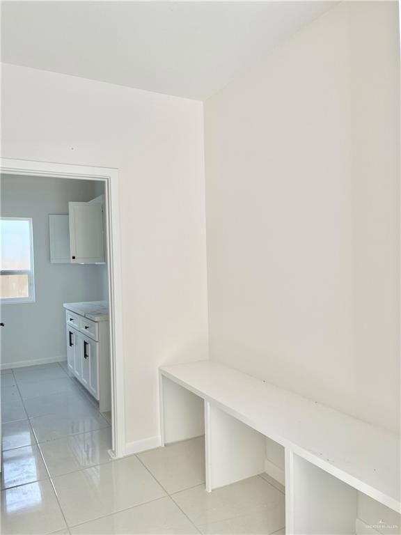 Mudroom featuring light tile floors