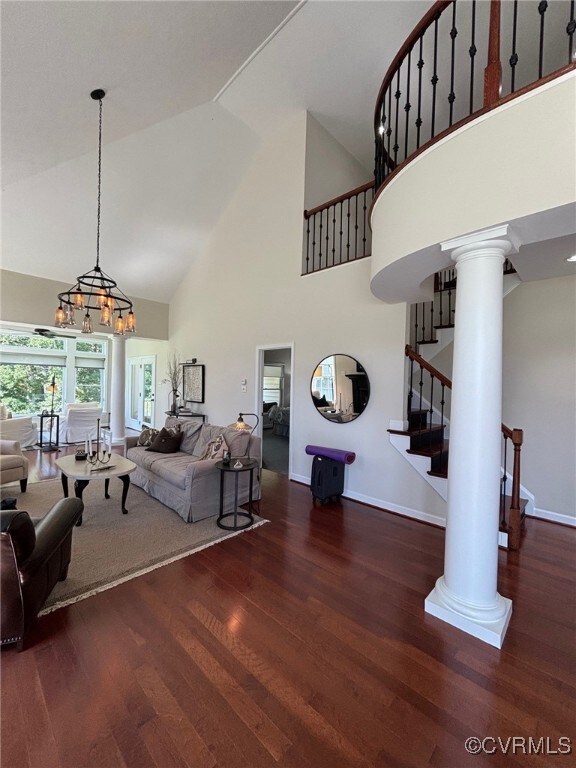 Living room with a high ceiling, an inviting chand