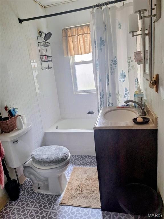 Full bath with shower / bath combo with shower curtain, vanity, and tile patterned flooring