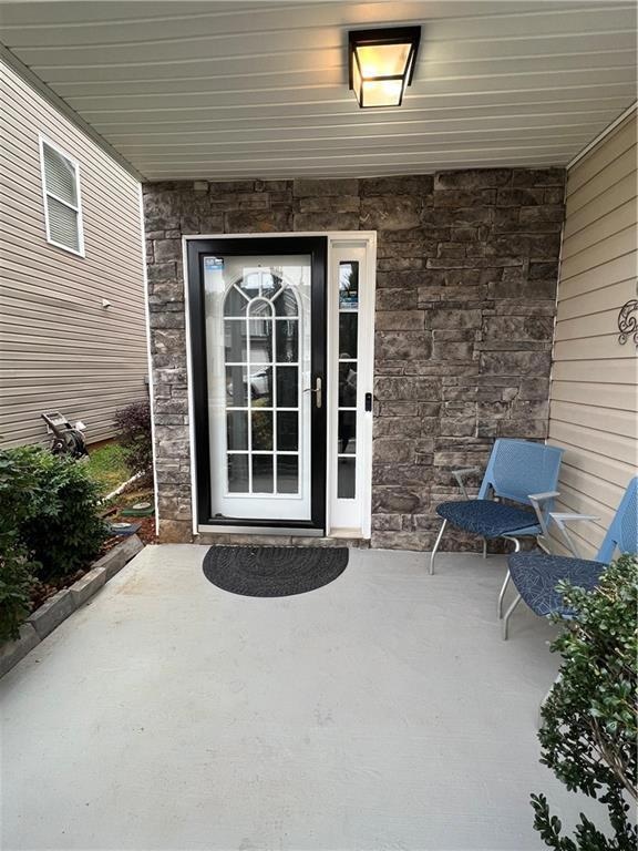 Entrance to property with stone siding