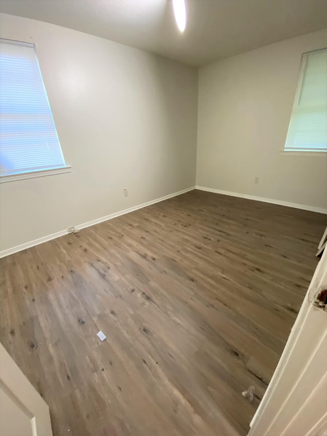 Unfurnished room featuring dark hardwood / wood-st