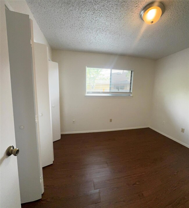 Unfurnished room featuring baseboards, wood finis
