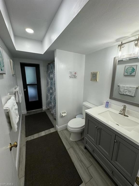 Bathroom featuring oversized vanity and toilet