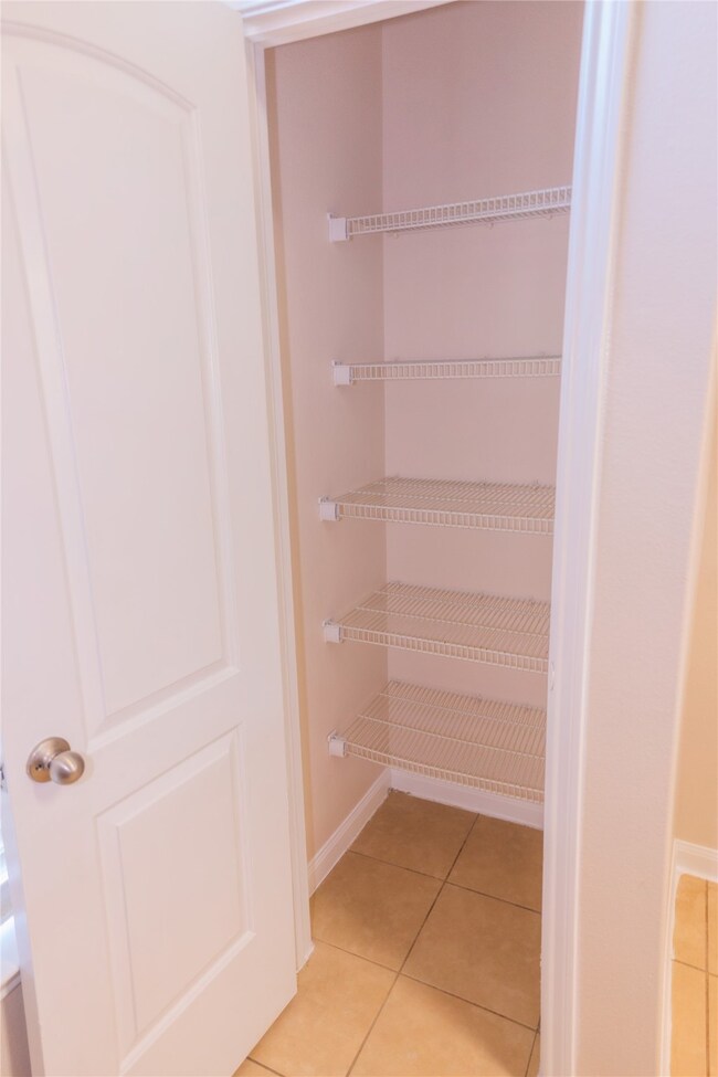 This photo shows a small pantry with wire shelving