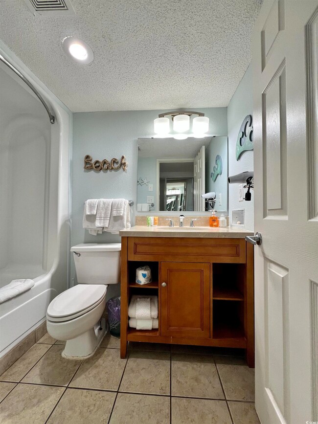 Bathroom featuring toilet, tile patterned flooring