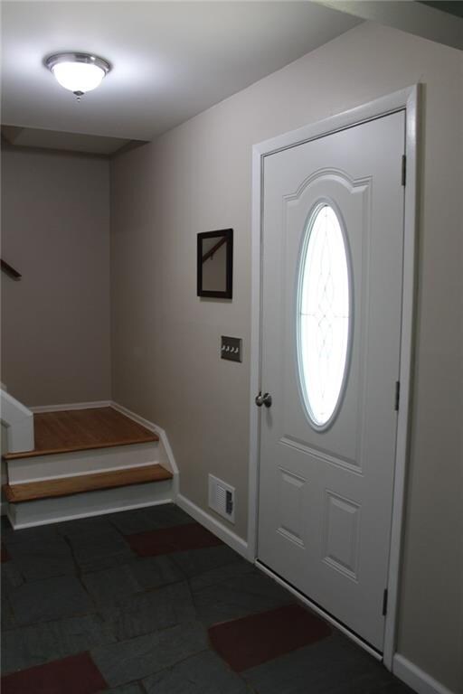 Spacious foyer with slate floor and new front door