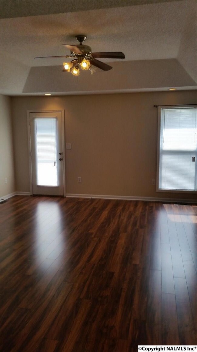 Tray ceiling, ceiling fan, new laminate wood flooring, fresh paint.