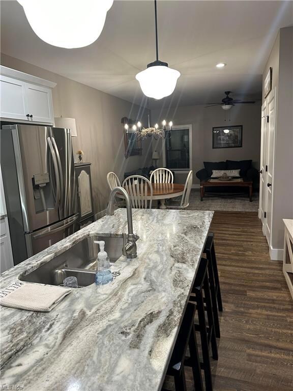 Kitchen with decorative light fixtures, a center i