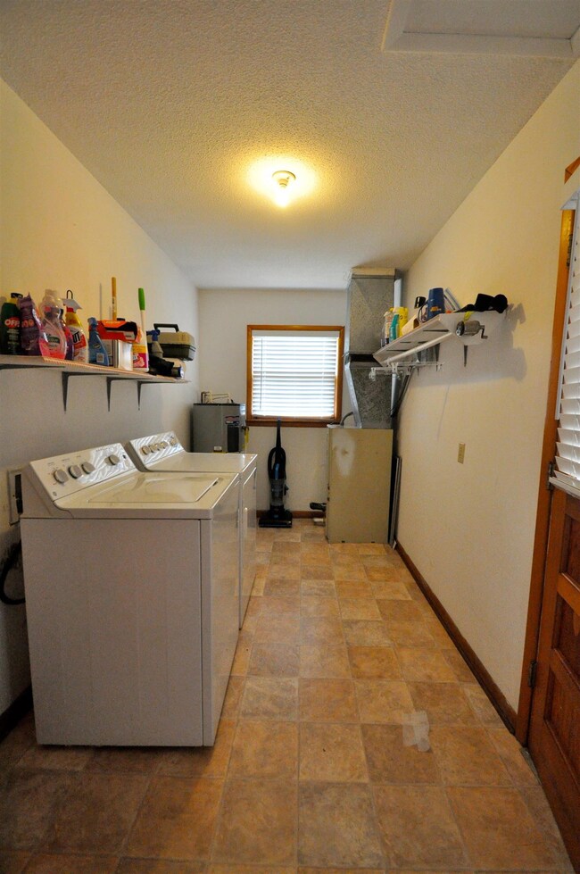 Laundry / Utility Room - Accessed by utilizing the door in the carport. 