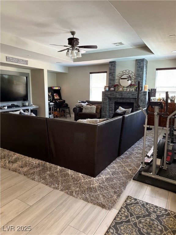 Living area featuring a raised ceiling, a ceiling