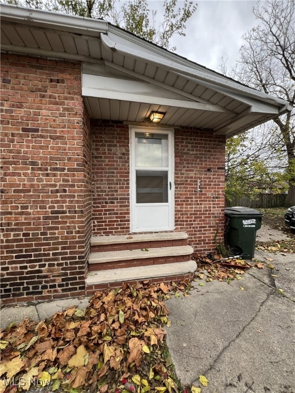 Side Doorway to property with brick siding