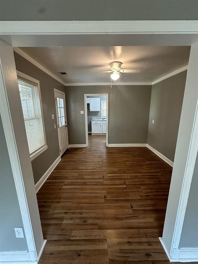 Interior space featuring crown molding, ceiling fa