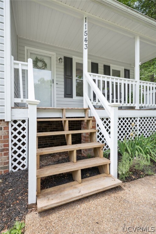Doorway to property with covered porch