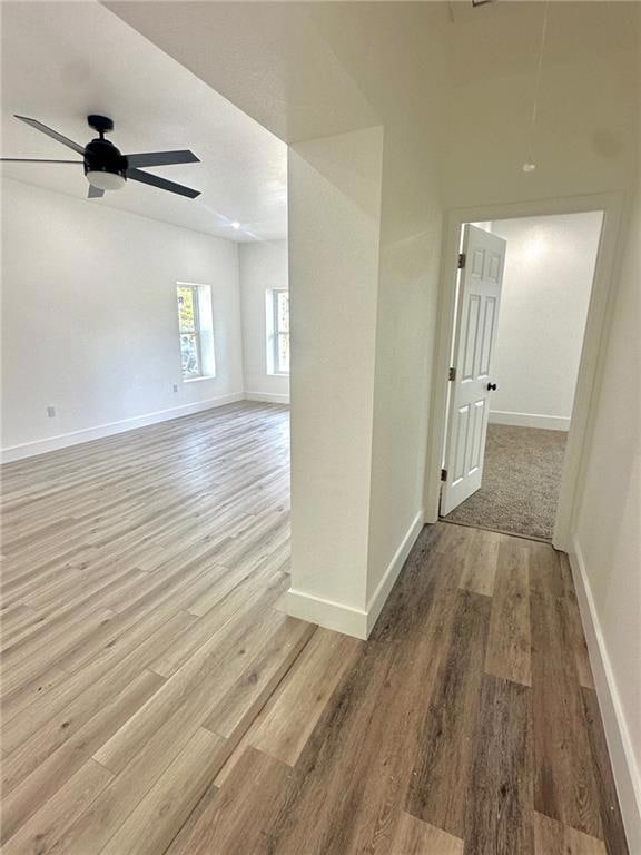 Hall featuring attic access and light wood-style floors