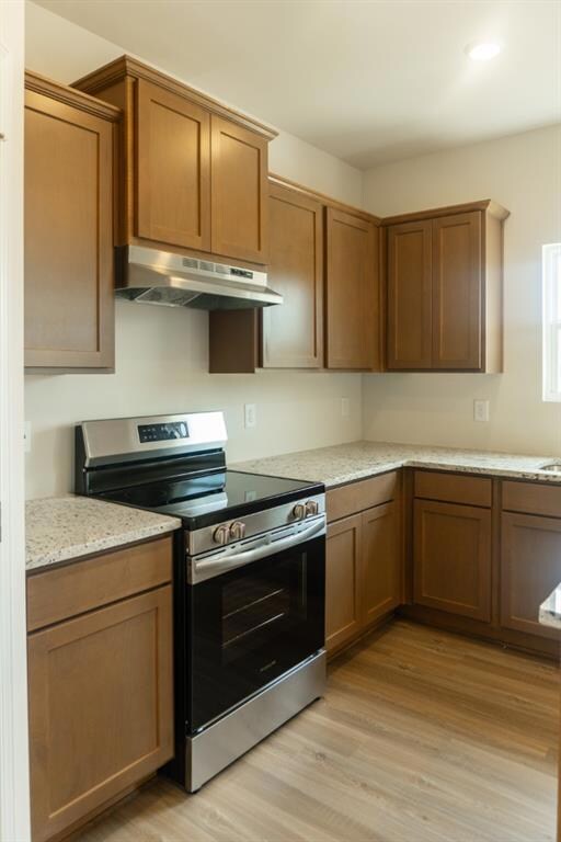 Kitchen featuring under cabinet range hood, electr