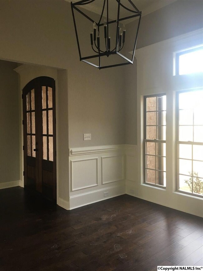 Dining room featuring custom trim, wainscoting and wide plank hardwoods.