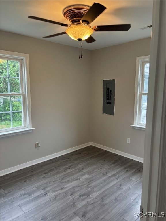 Empty room featuring electric panel, ceiling fan,