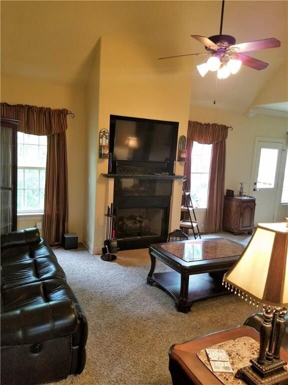 Living Room with cathedral ceilings and gas log fireplace.