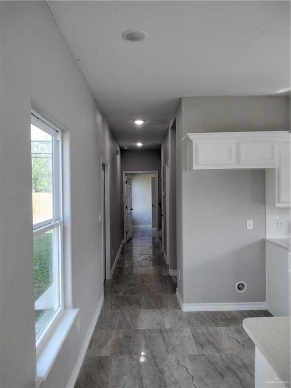 Hallway featuring baseboards