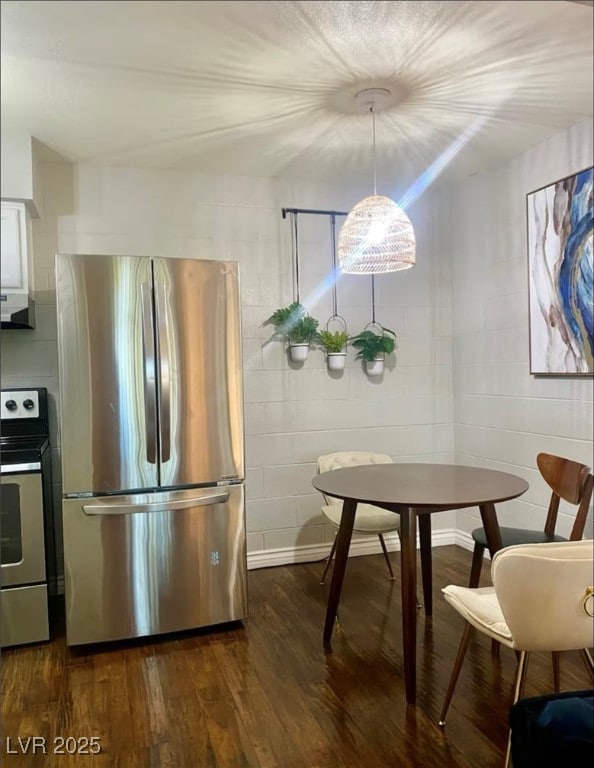 Kitchen featuring stainless steel appliances, dark wood-type flooring, under cabinet range hood, and white cabinets