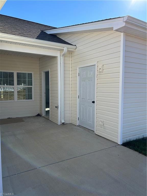 Back patio with adjacent storage room