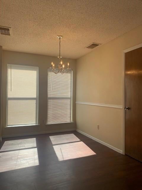 Unfurnished dining area with a chandelier, wood f