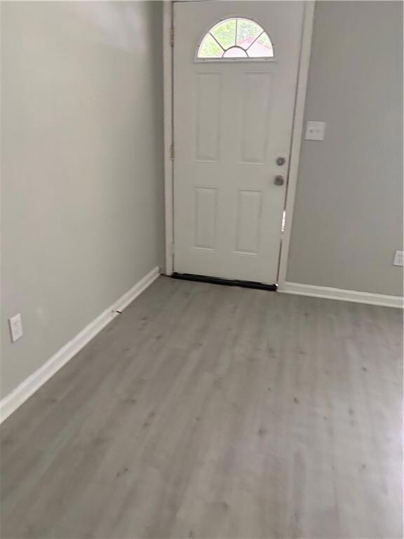 Entrance foyer featuring wood finished floors and baseboards