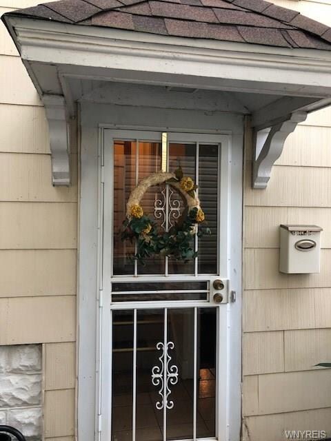 Entry to house with gated yard with mailbox as wel