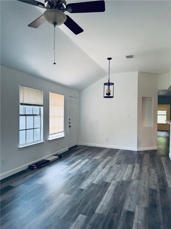 Spare room featuring lofted ceiling, ceiling fan,