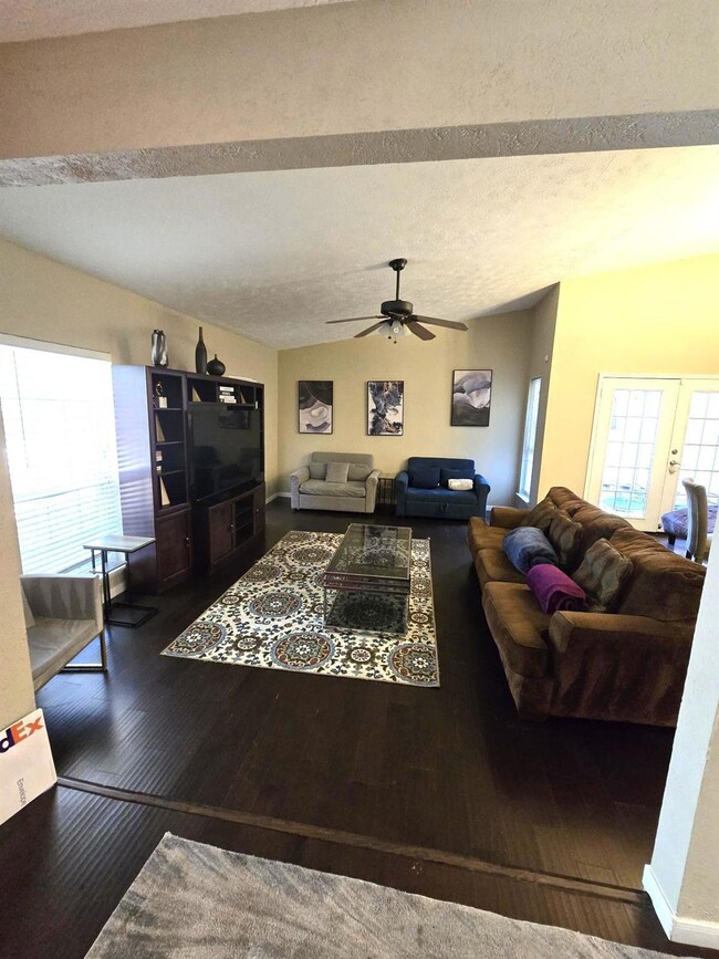 Living area featuring a textured ceiling, wood fin
