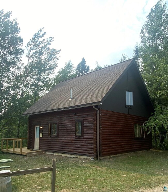 View of side of home featuring a lawn