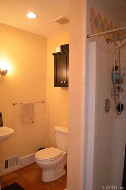 Full bath near the exit to the back yard pool and 