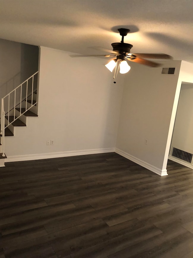 Unfurnished room with dark wood-type flooring and 