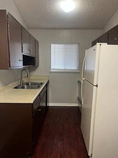 Kitchen with freestanding refrigerator, a sink, d