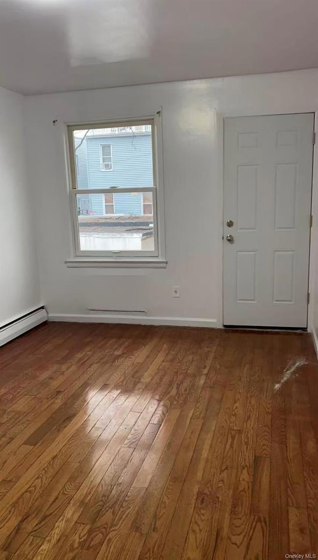 Entryway featuring hardwood / wood-style flooring and a baseboard radiator