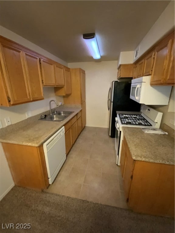 Kitchen with dishwashing machine, stove, a sink, a