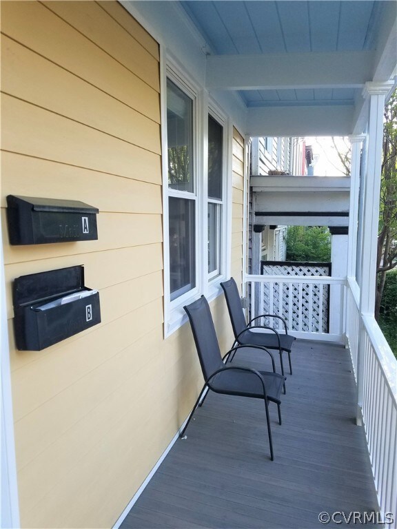 Covered front porch. Notice the blue painted ceili