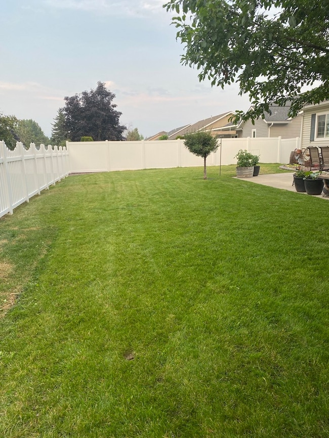 Fenced backyard with a patio area