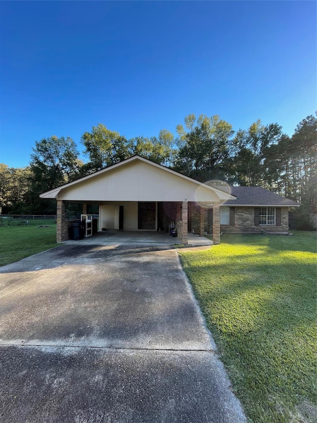 Single story home featuring a carport and a front 