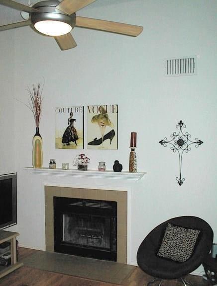 Detailed view of a tiled fireplace and wood finished floors