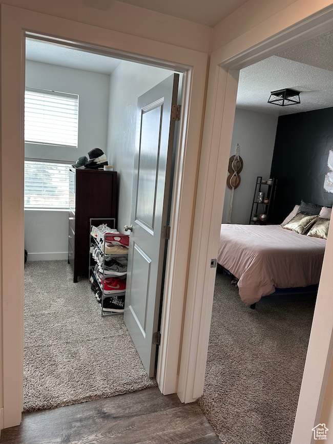 Bedroom featuring carpet and a textured ceiling